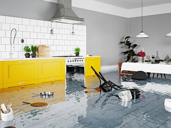 Chaos in a flooded modern kitchen after a home disaster. Water damage and insurance claim concept. 3D rendering.